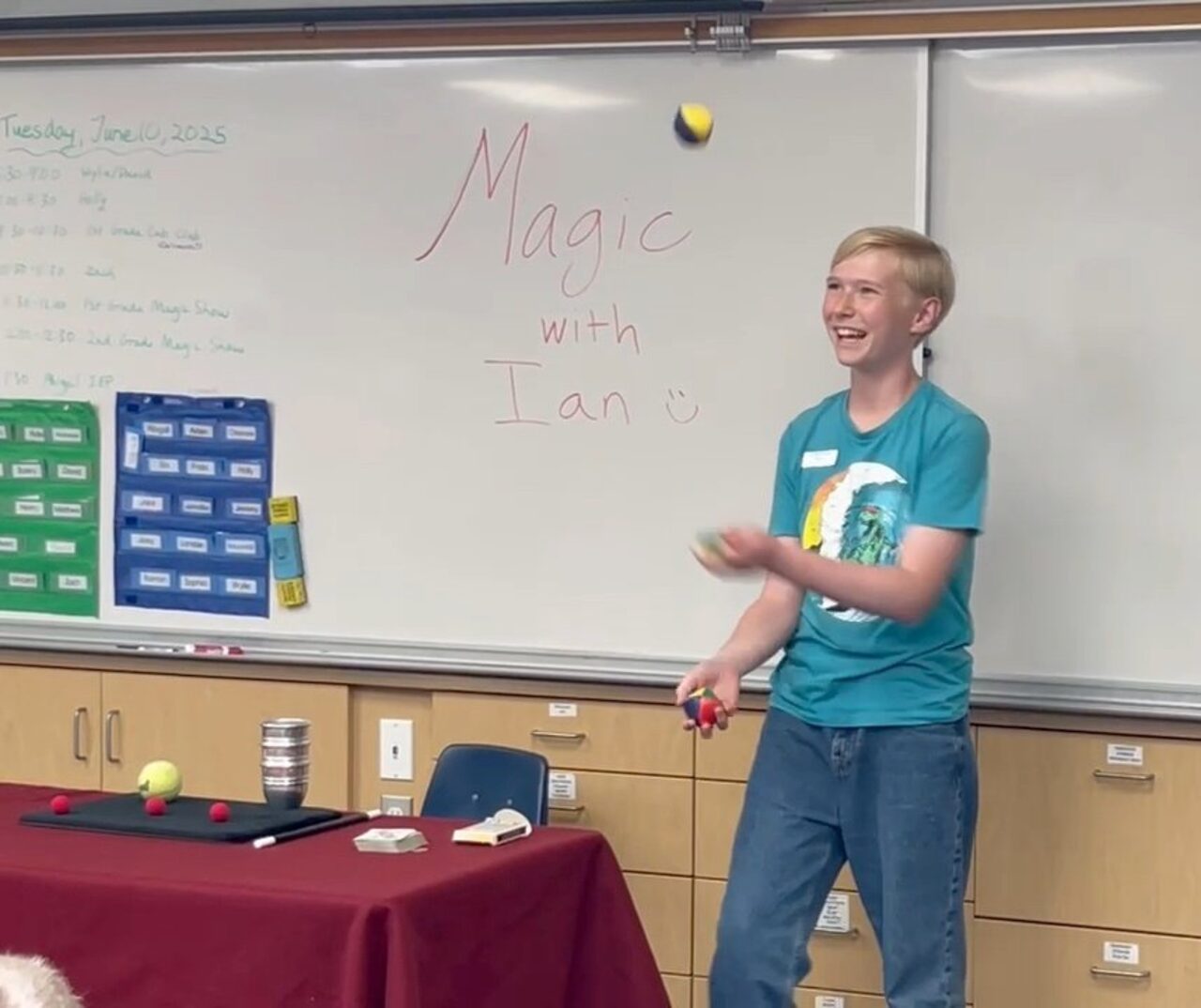 Ian Gustafson performing magic for a school audience